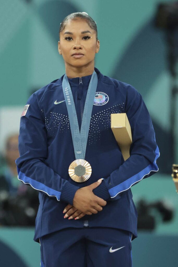 Jordan Chiles standing solemnly with Olympic medal box after medal stripped