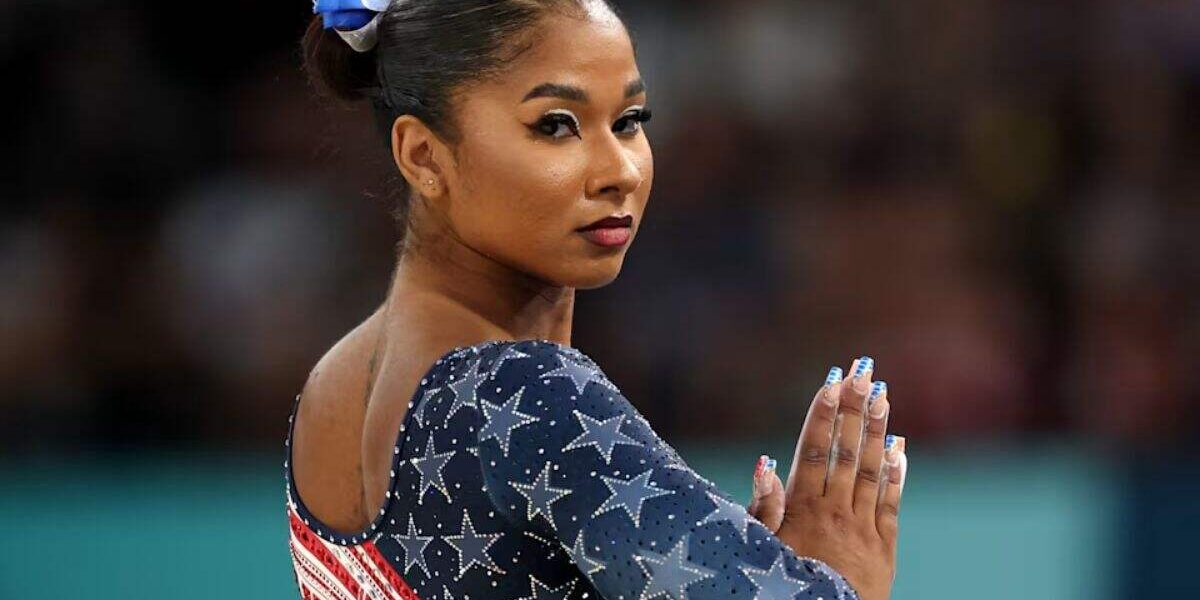 Jordan Chiles performing floor exercise in Team USA leotard looking determined during Olympics